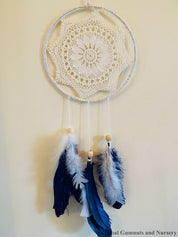 Navy blue baby boy dream catcher mobile, featuring feathers and a blue-and-white design for a soothing nursery.