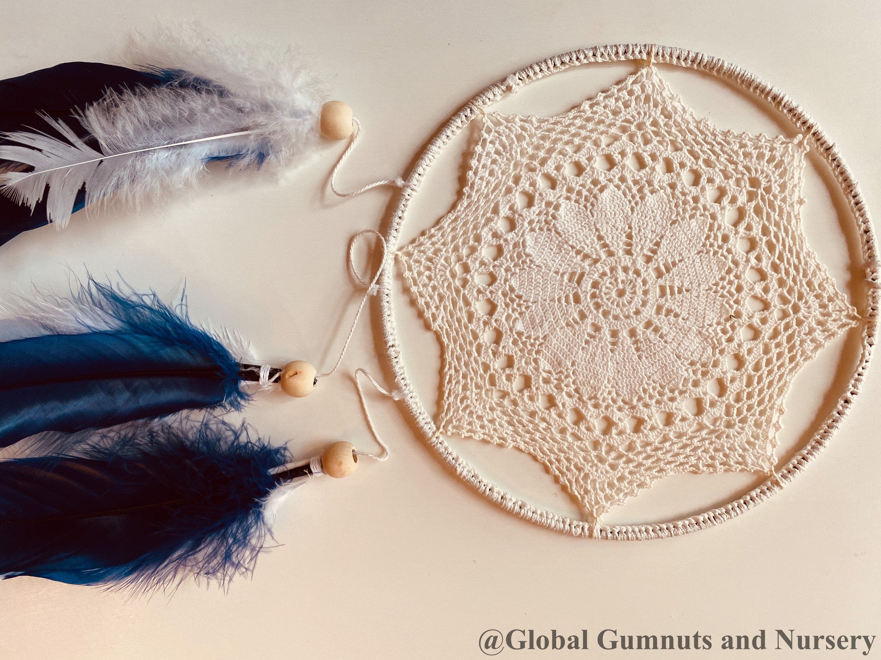 Navy blue baby boy dream catcher mobile, featuring feathers and a blue-and-white design for a soothing nursery.
