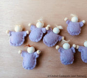 Tiny felt worry dolls, comforting companions designed to help children with big worries.