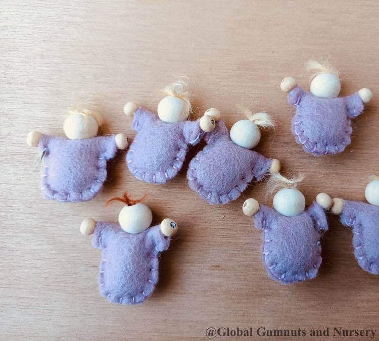 Tiny felt worry dolls, comforting companions designed to help children with big worries.