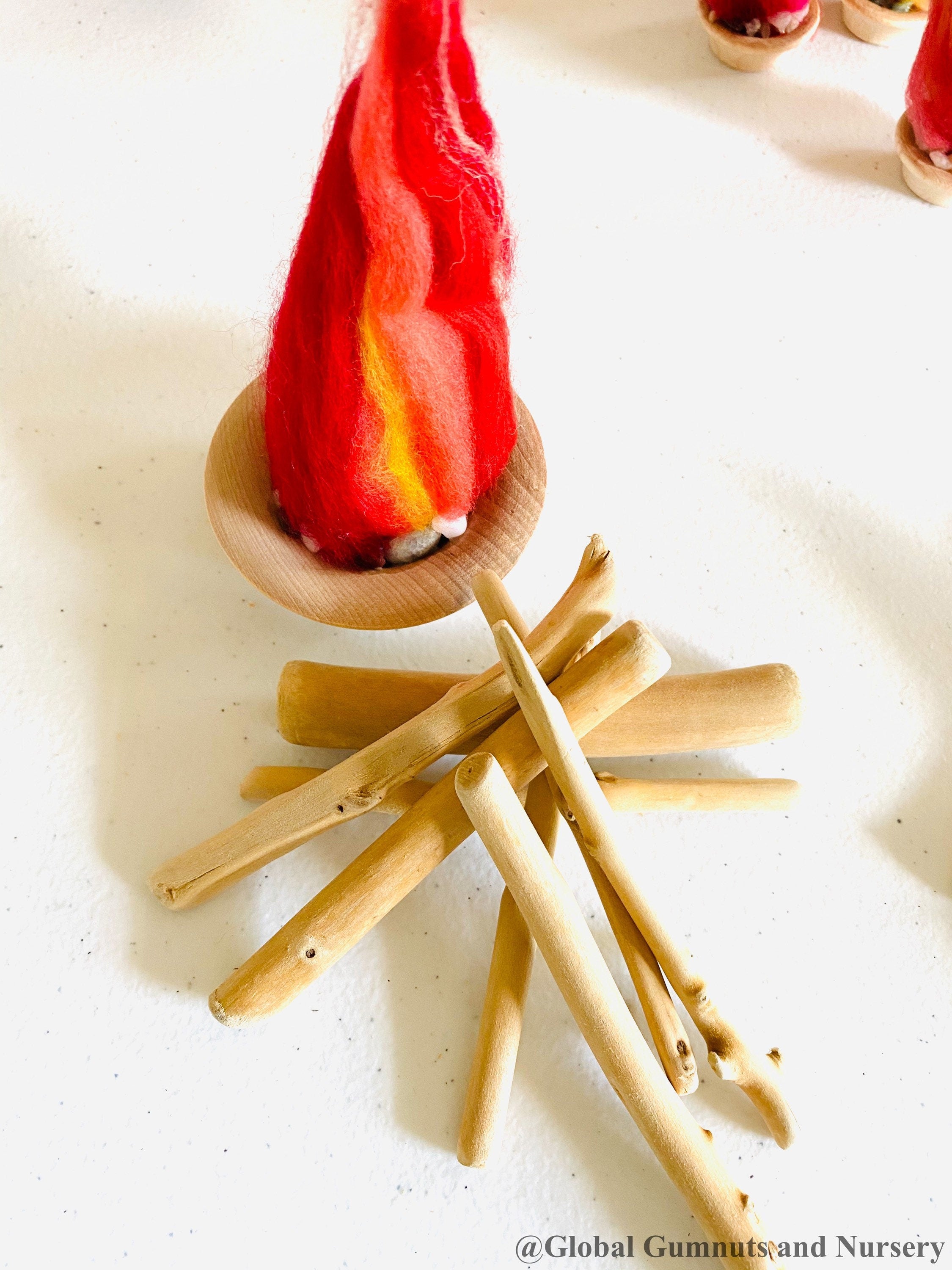 Felt Fireplace Set: Felt fireplace with decorative firewood and stones.