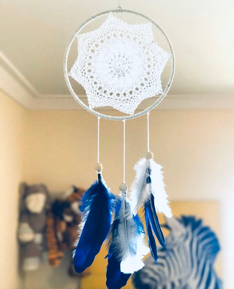 Navy blue baby boy dream catcher mobile, featuring feathers and a blue-and-white design for a soothing nursery.

