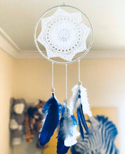 Navy blue baby boy dream catcher mobile, featuring feathers and a blue-and-white design for a soothing nursery.
