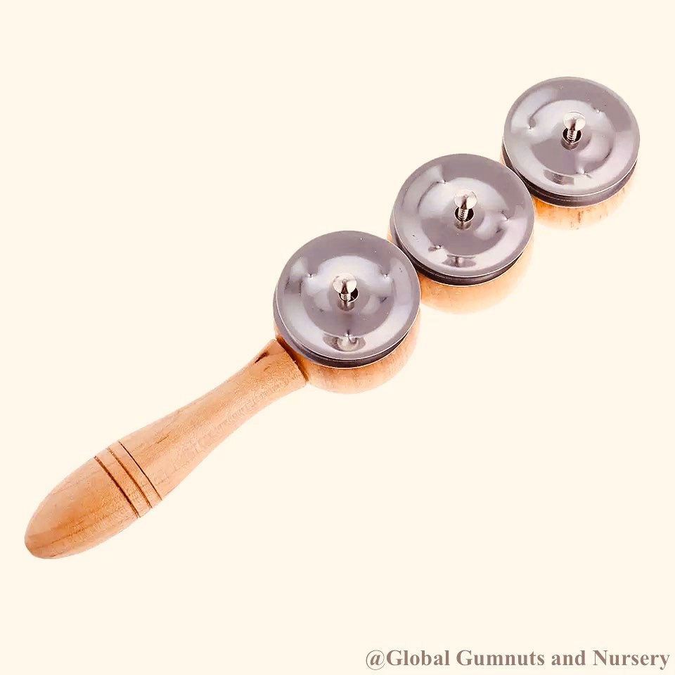 Jackie’s triple symbol shakers, a tactile and colorful musical instrument for play and rhythm exploration.