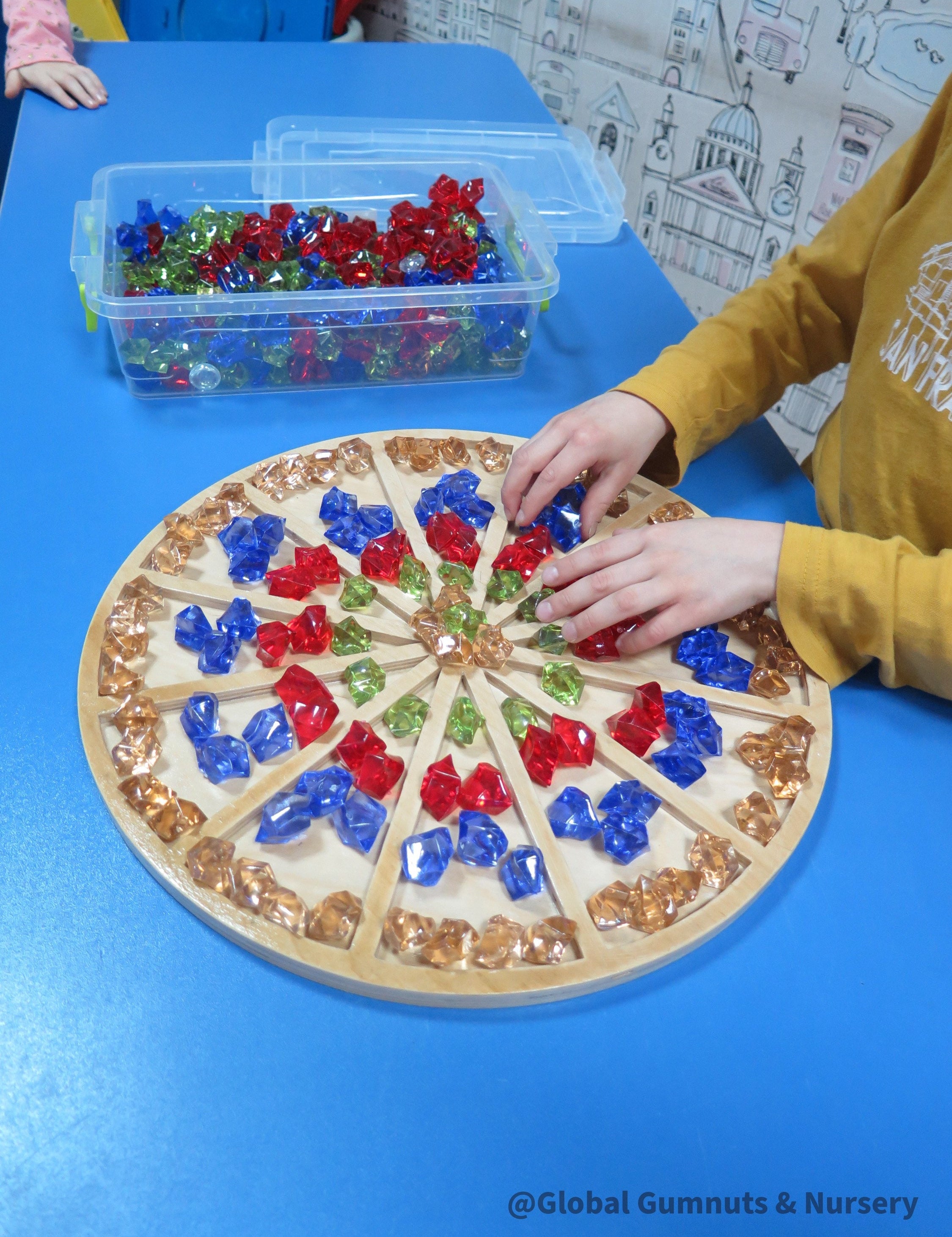 Wooden sorting board with 12 colorful sections for educational activities like counting, color sorting, and clock learning.
