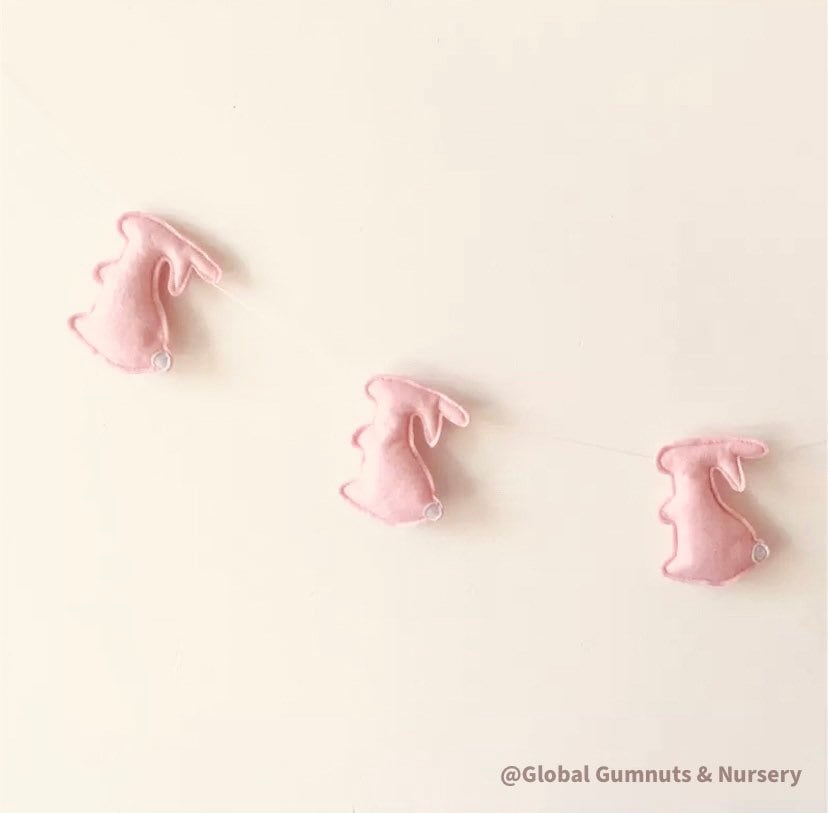 Rabbit garland, a charming nursery or baby shower decor with felt rabbits and bunting.
