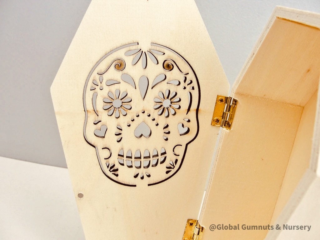 Wooden coffin, perfect for Halloween décor featuring sugar skull or skeleton themes.
