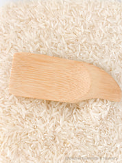 Flat rectangle scooper made of natural wood, perfect for sensory play and Montessori activities.