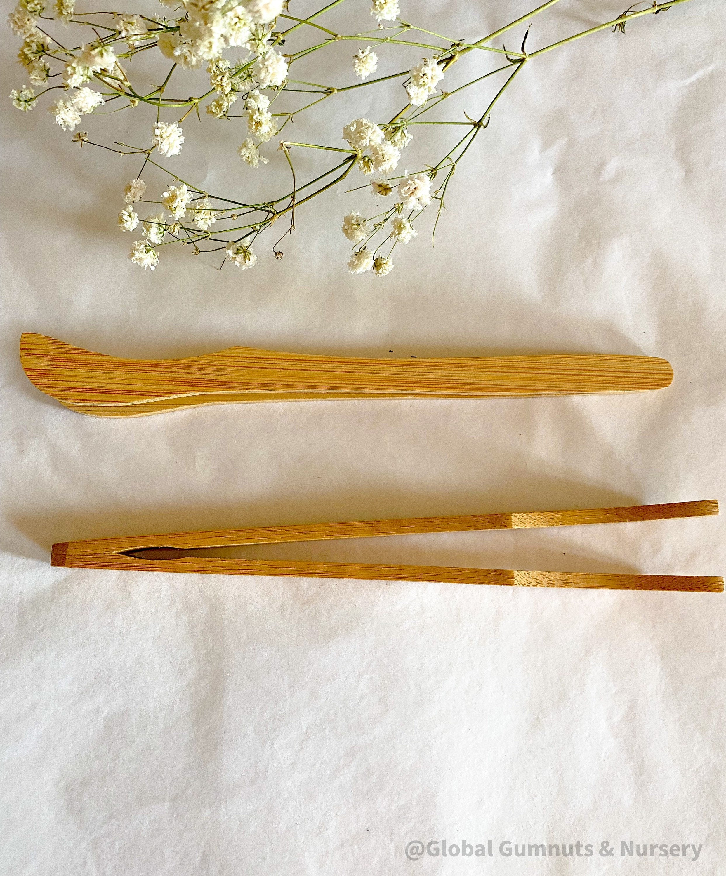 Wooden Toddler Tongs: Curved wooden tongs designed for toddlers' motor skill development.