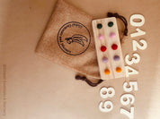 tens board with felt balls and numbers: educational toy with mini felt balls and wooden numbers, made from 100% nz wool, for play-based counting activities.