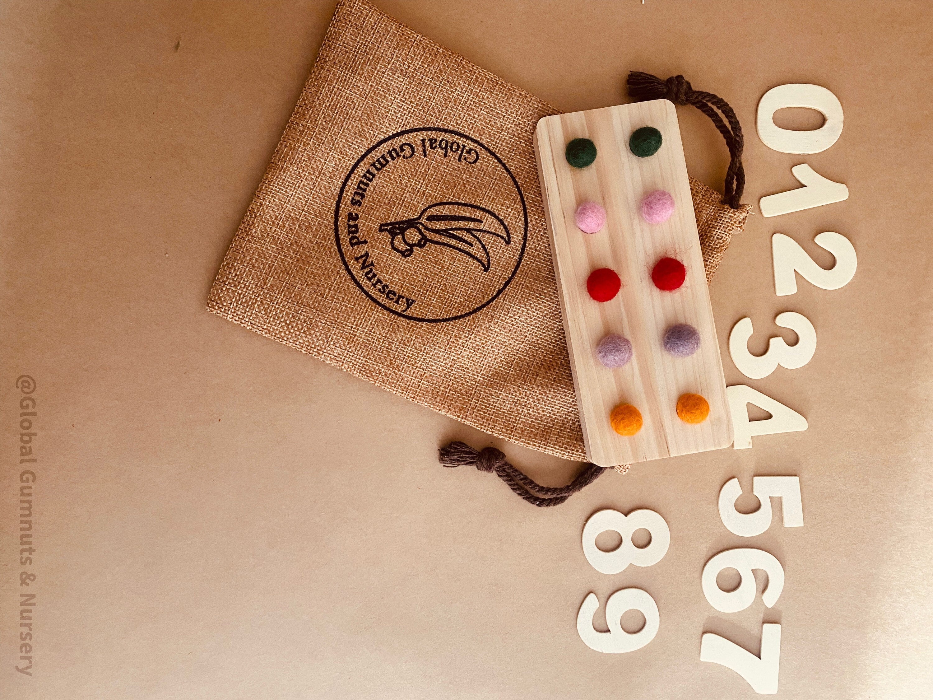tens board with felt balls and numbers: educational toy with mini felt balls and wooden numbers, made from 100% nz wool, for play-based counting activities.