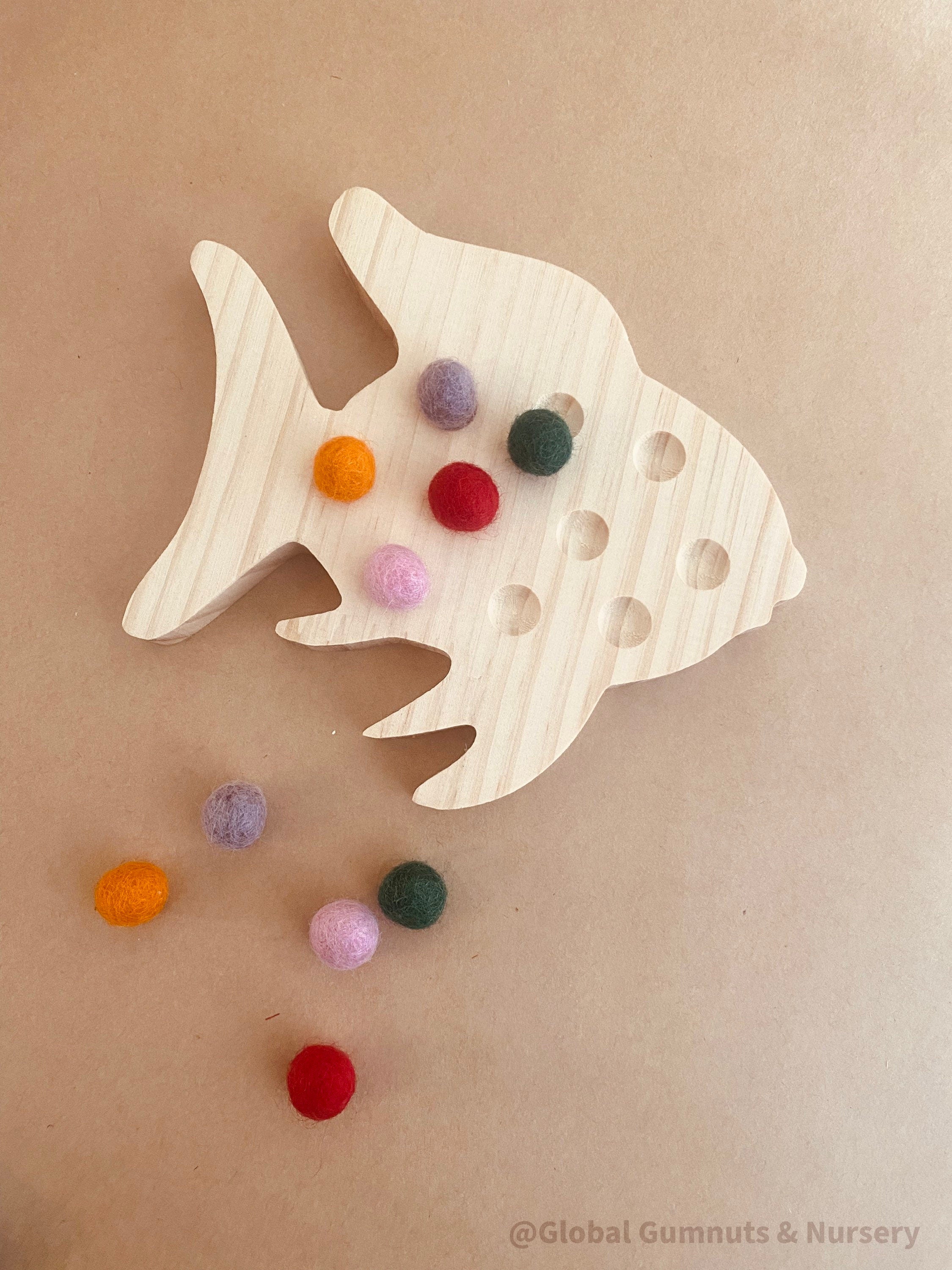 rainbow fish tens board: montessori-style tens board featuring colourful felt balls and wooden numbers, designed for teaching counting and early math skills.