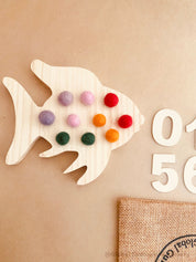 rainbow fish tens board: montessori-style tens board featuring colourful felt balls and wooden numbers, designed for teaching counting and early math skills.