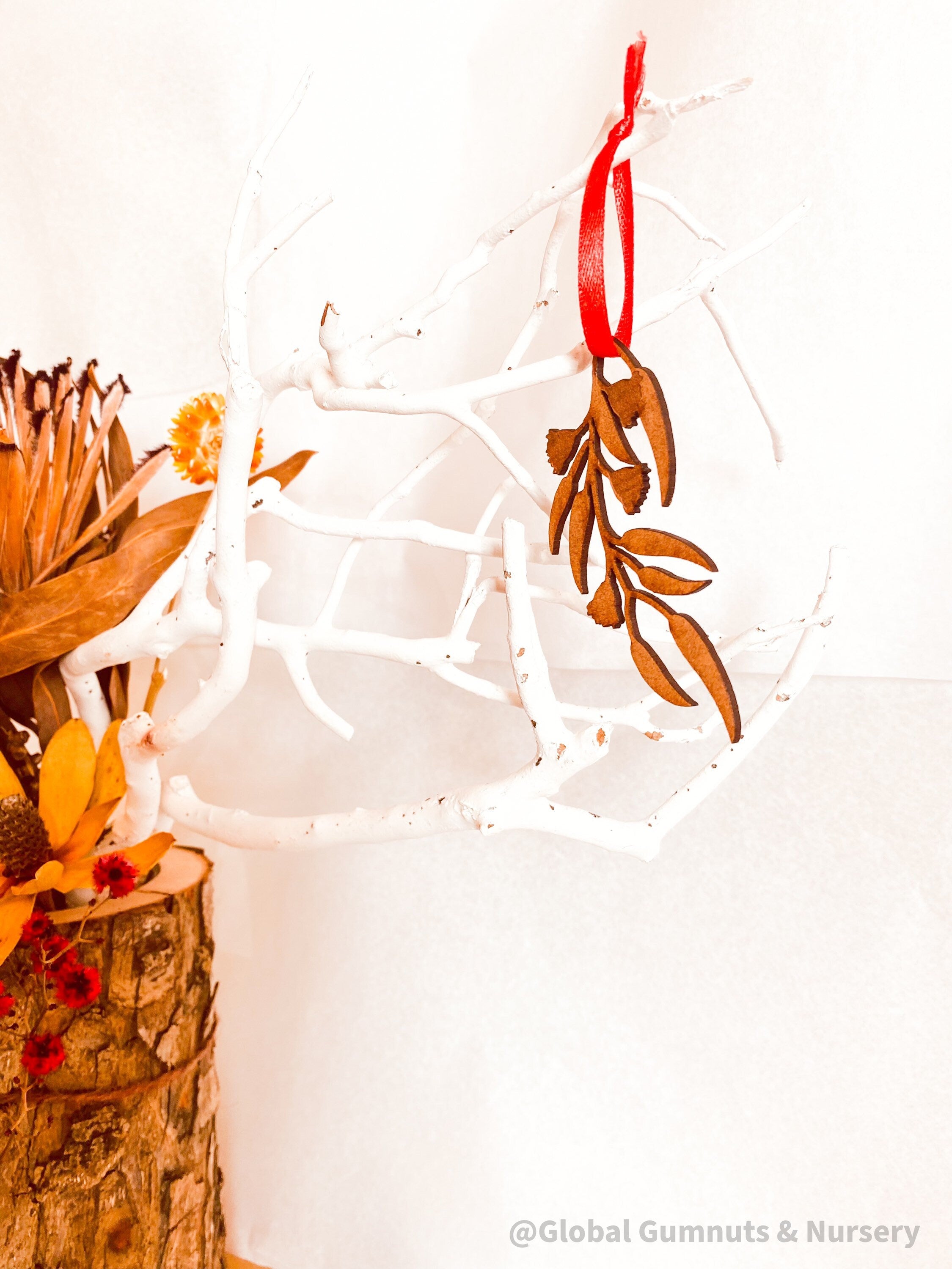 Eucalyptus Branch Ornament: Eucalyptus-themed ornament for festive displays.