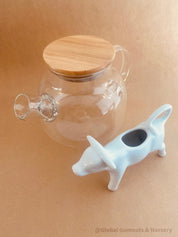 Glass Teapot with Bamboo Lid: Stylish glass teapot with bamboo lid, perfect for tea time or as a display piece for modern decor.