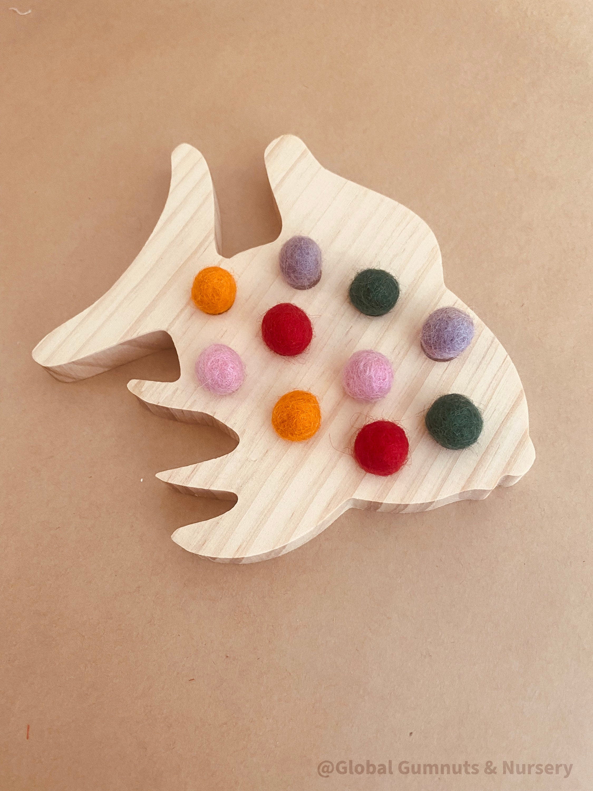 rainbow fish tens board: montessori-style tens board featuring colourful felt balls and wooden numbers, designed for teaching counting and early math skills.