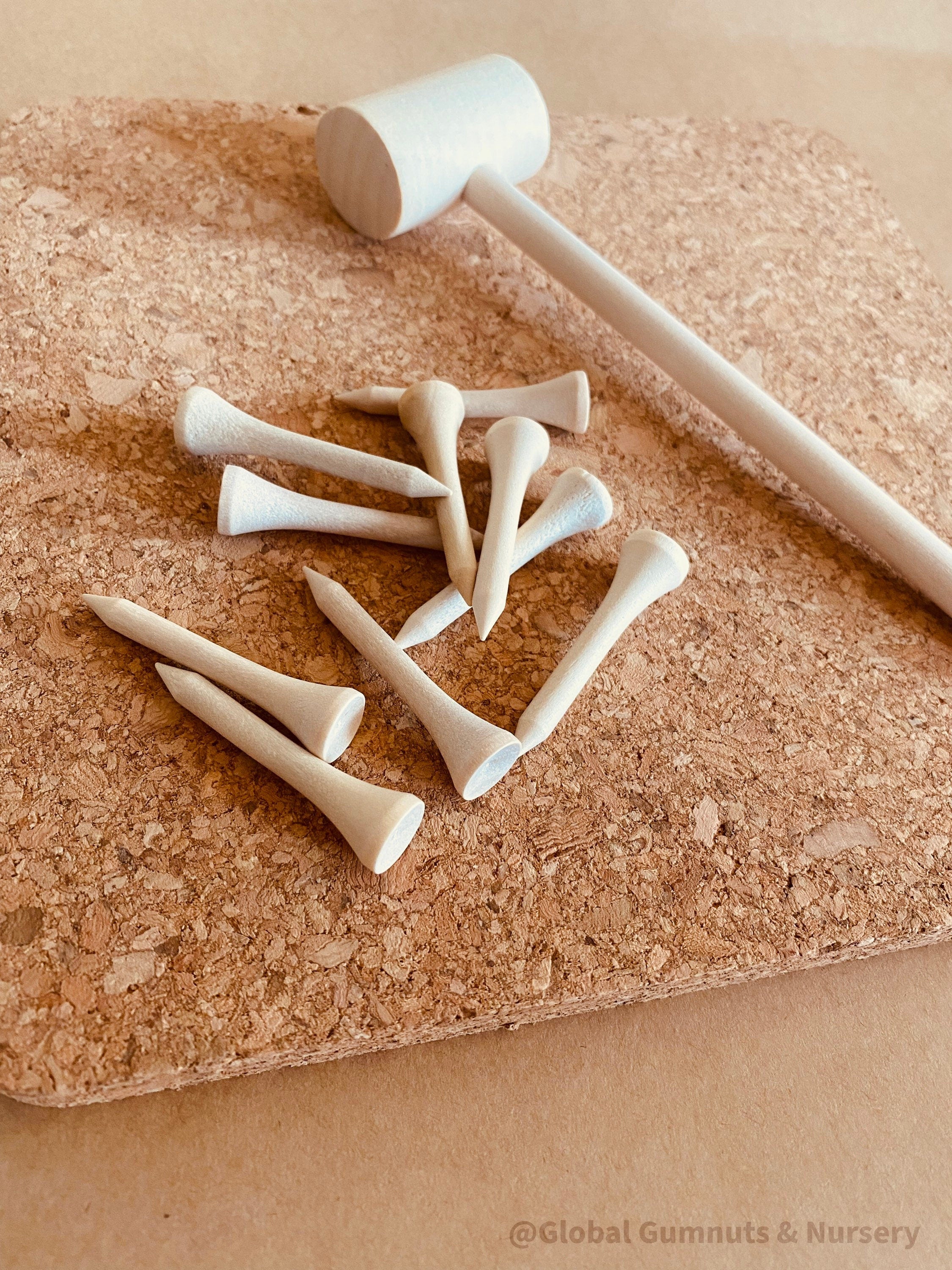 CORK and Tools Set: Kids’ wooden hammer and nail set with corkboard and wooden nails for creative crafting and playdough fun.