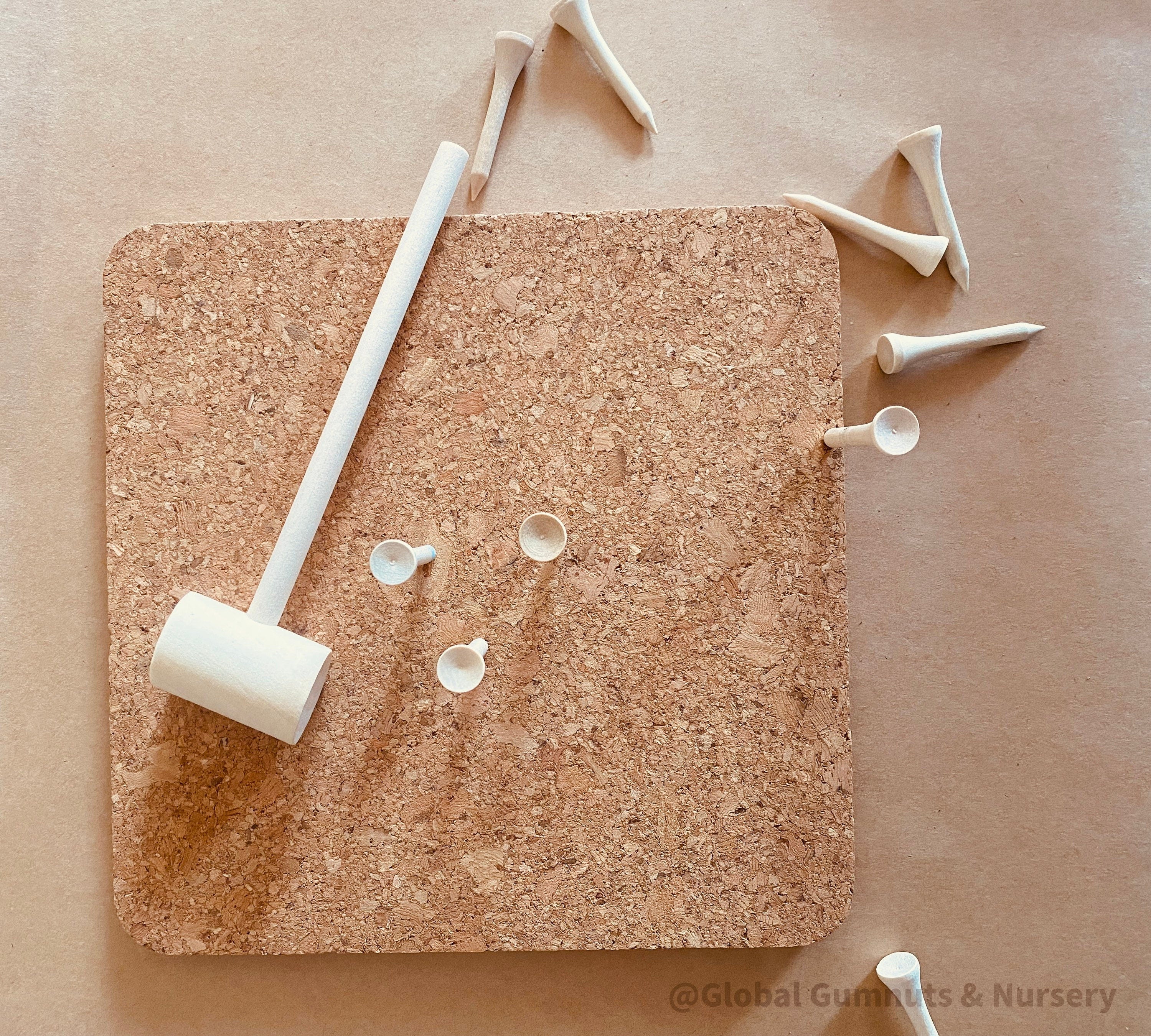 CORK and Tools Set: Kids’ wooden hammer and nail set with corkboard and wooden nails for creative crafting and playdough fun.