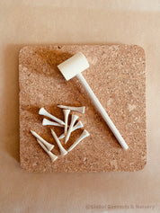 CORK and Tools Set: Kids’ wooden hammer and nail set with corkboard and wooden nails for creative crafting and playdough fun.