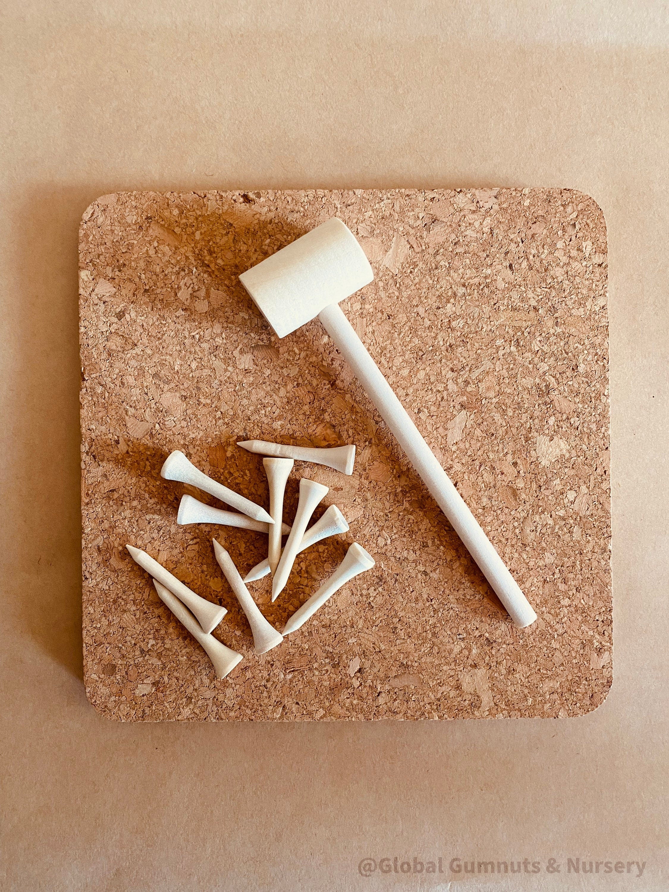 CORK and Tools Set: Kids’ wooden hammer and nail set with corkboard and wooden nails for creative crafting and playdough fun.