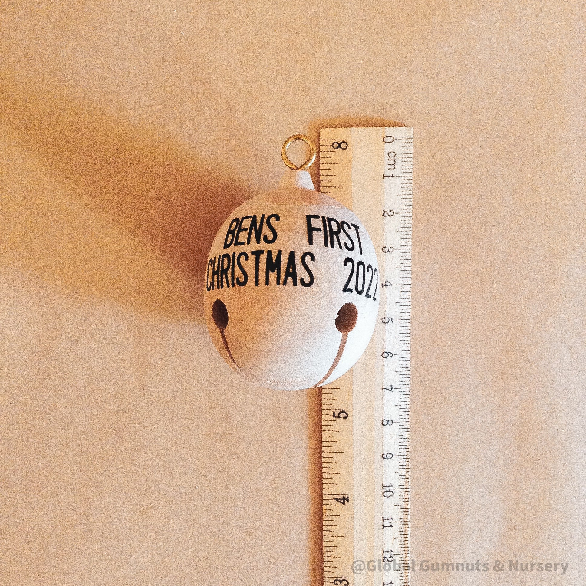 Wooden bell Christmas ornament with chimes, perfect for festive tree decor or rustic holiday charm.