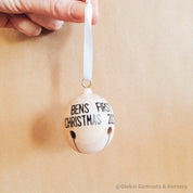 Wooden bell Christmas ornament with chimes, perfect for festive tree decor or rustic holiday charm.