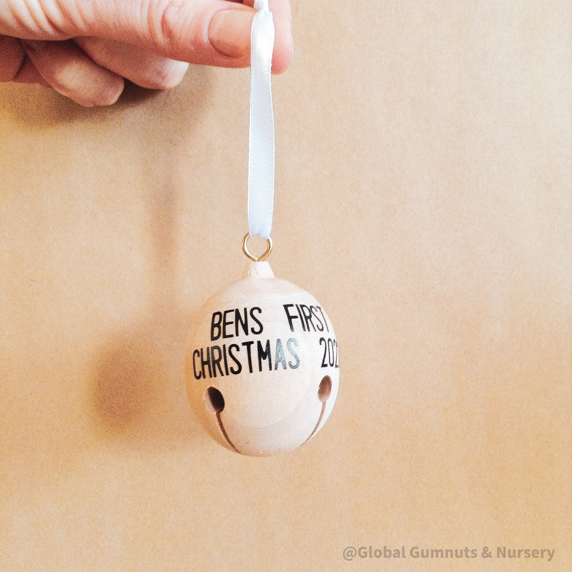 Wooden bell Christmas ornament with chimes, perfect for festive tree decor or rustic holiday charm.