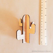 Wooden cactus decor piece, perfect for pretend play or as a cake topper.