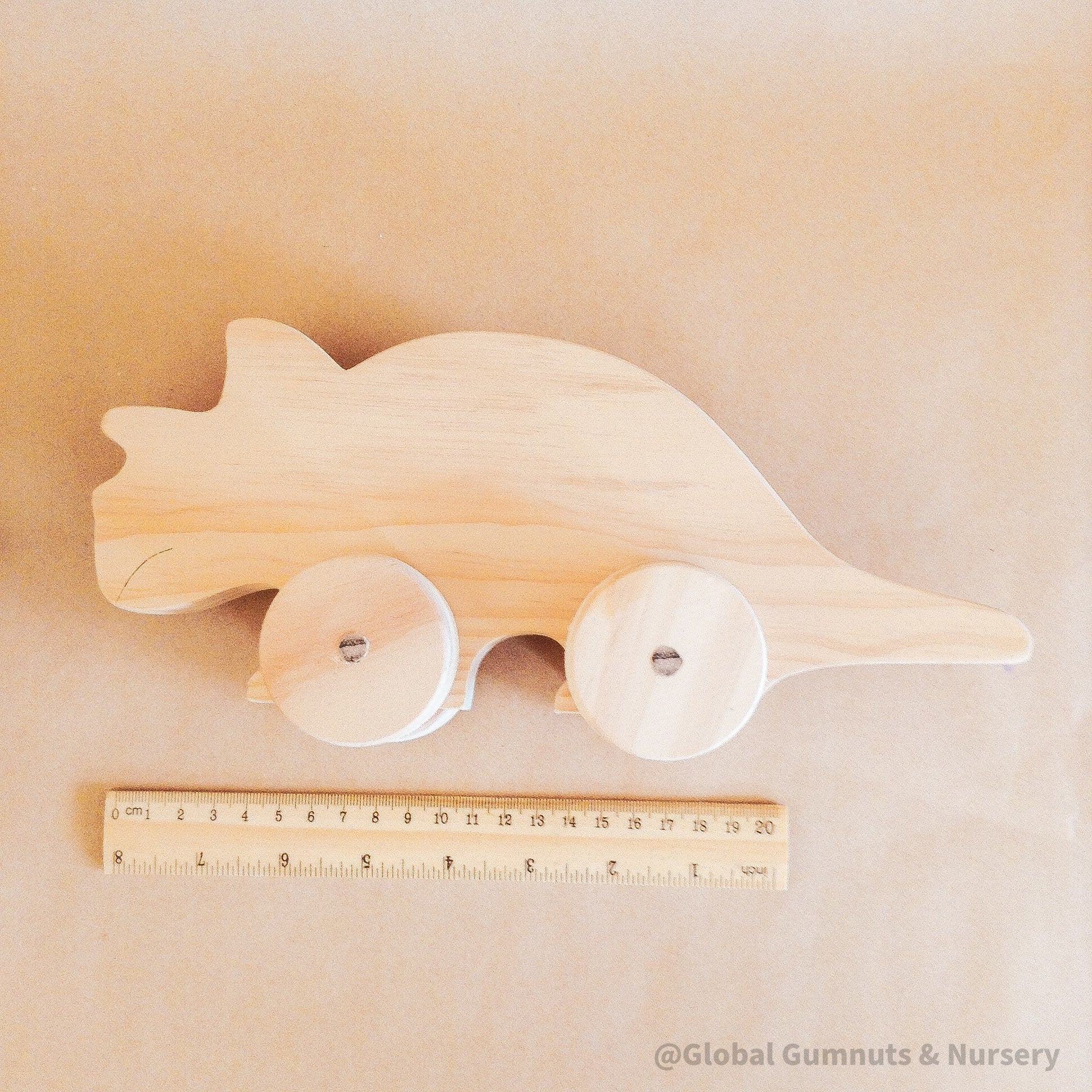 Wooden Dinosaur Push Pull Toy: Handmade wooden dinosaur on wheels for imaginative play.