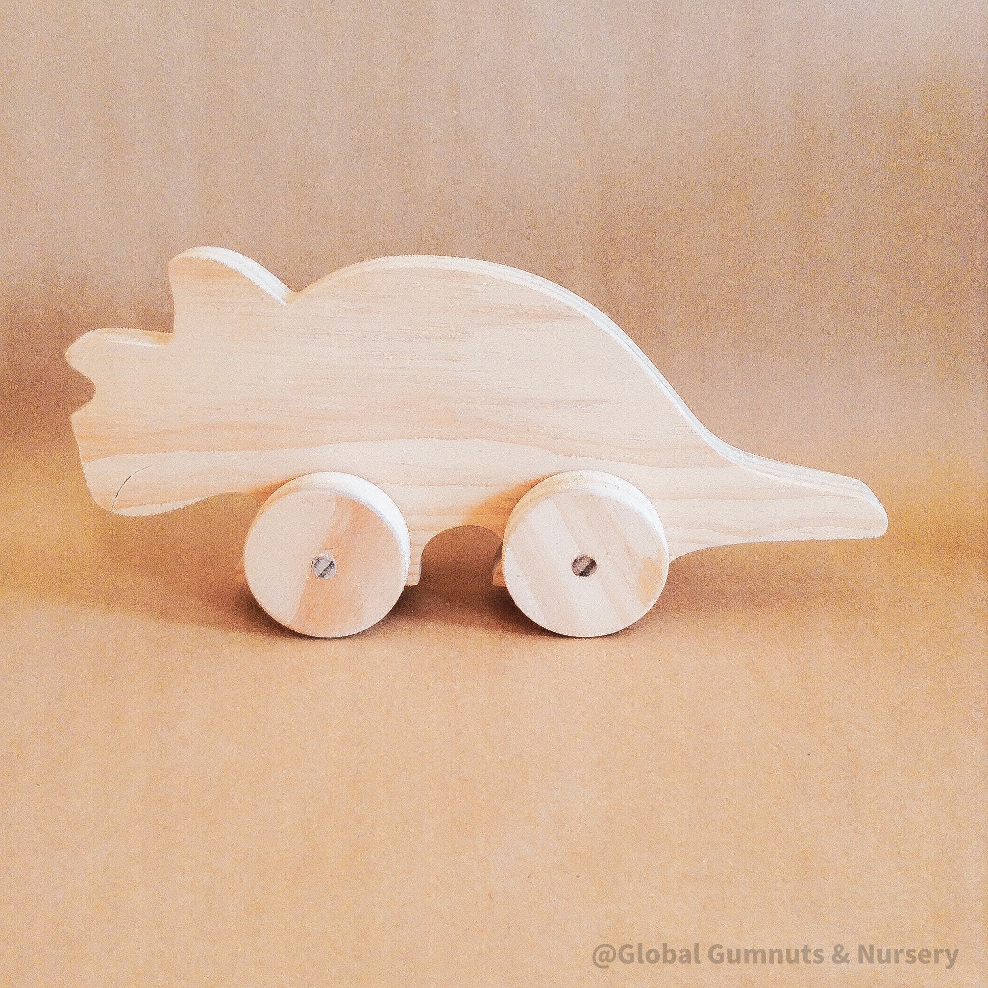 Wooden Dinosaur Push Pull Toy: Handmade wooden dinosaur on wheels for imaginative play.