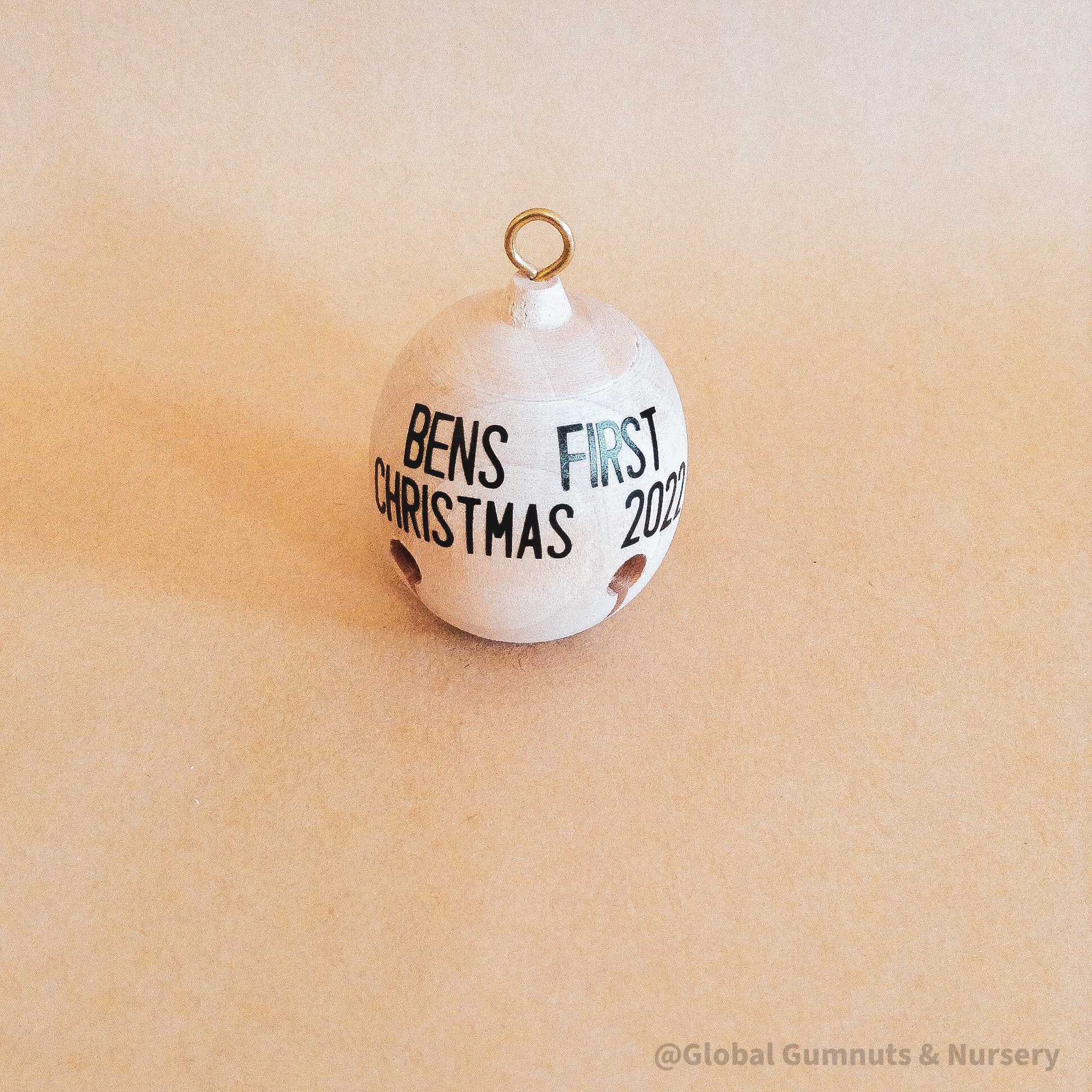 Wooden bell Christmas ornament with chimes, perfect for festive tree decor or rustic holiday charm.
