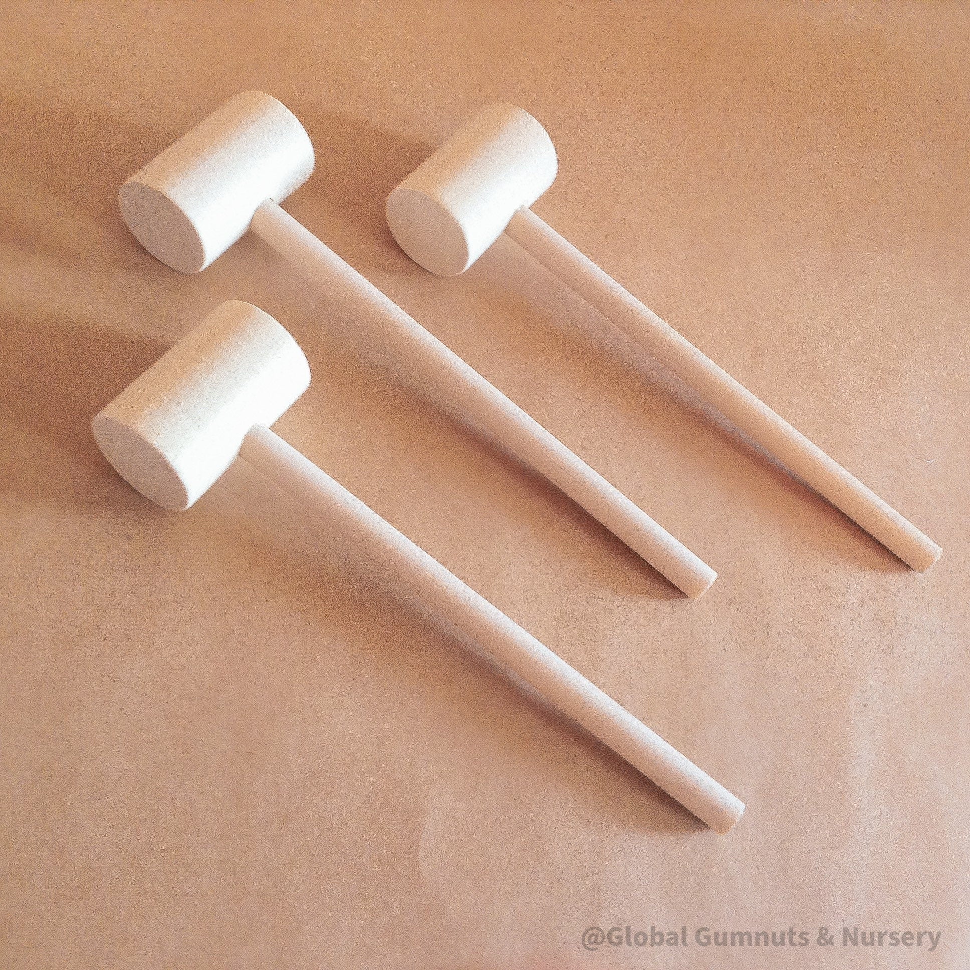child wooden hammer: child-sized wooden hammer for sensory and motor skills development.