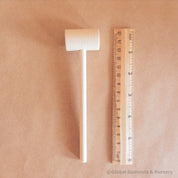 Child Wooden Hammer: Child-sized wooden hammer for sensory and motor skills development.