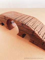 Handcrafted wooden bridge with three passages, perfect for fairy gardens or magical small-world play.
