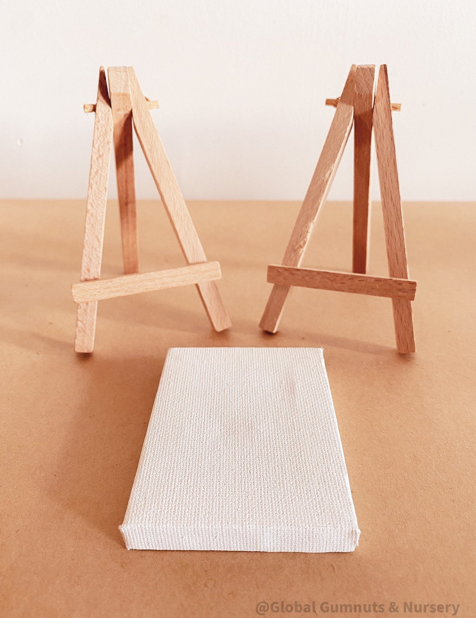 Miniature wooden easel and canvas set, ideal for inspiring tiny artists.
