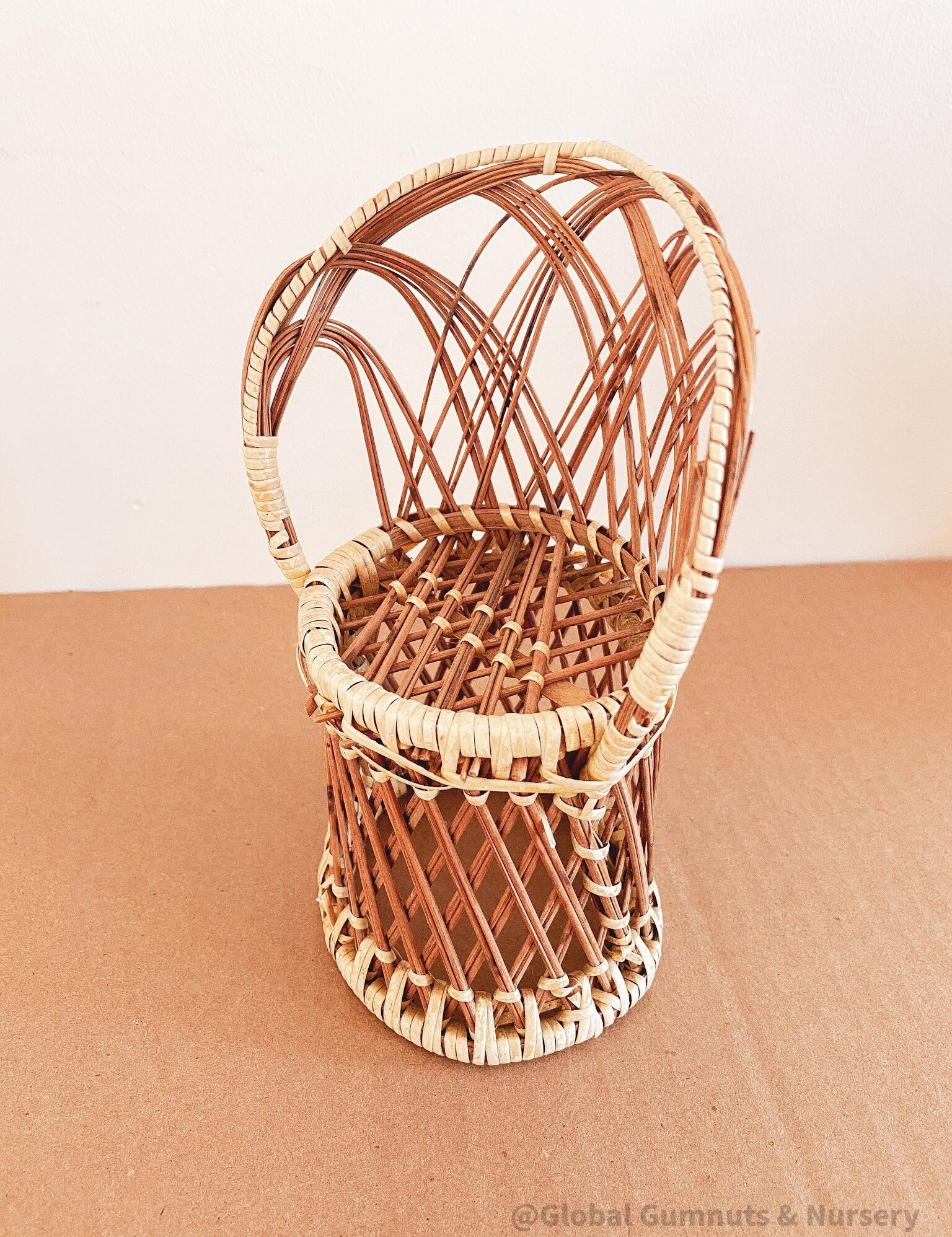 Vintage wicker doll's chair, measuring 20cm x 10cm.