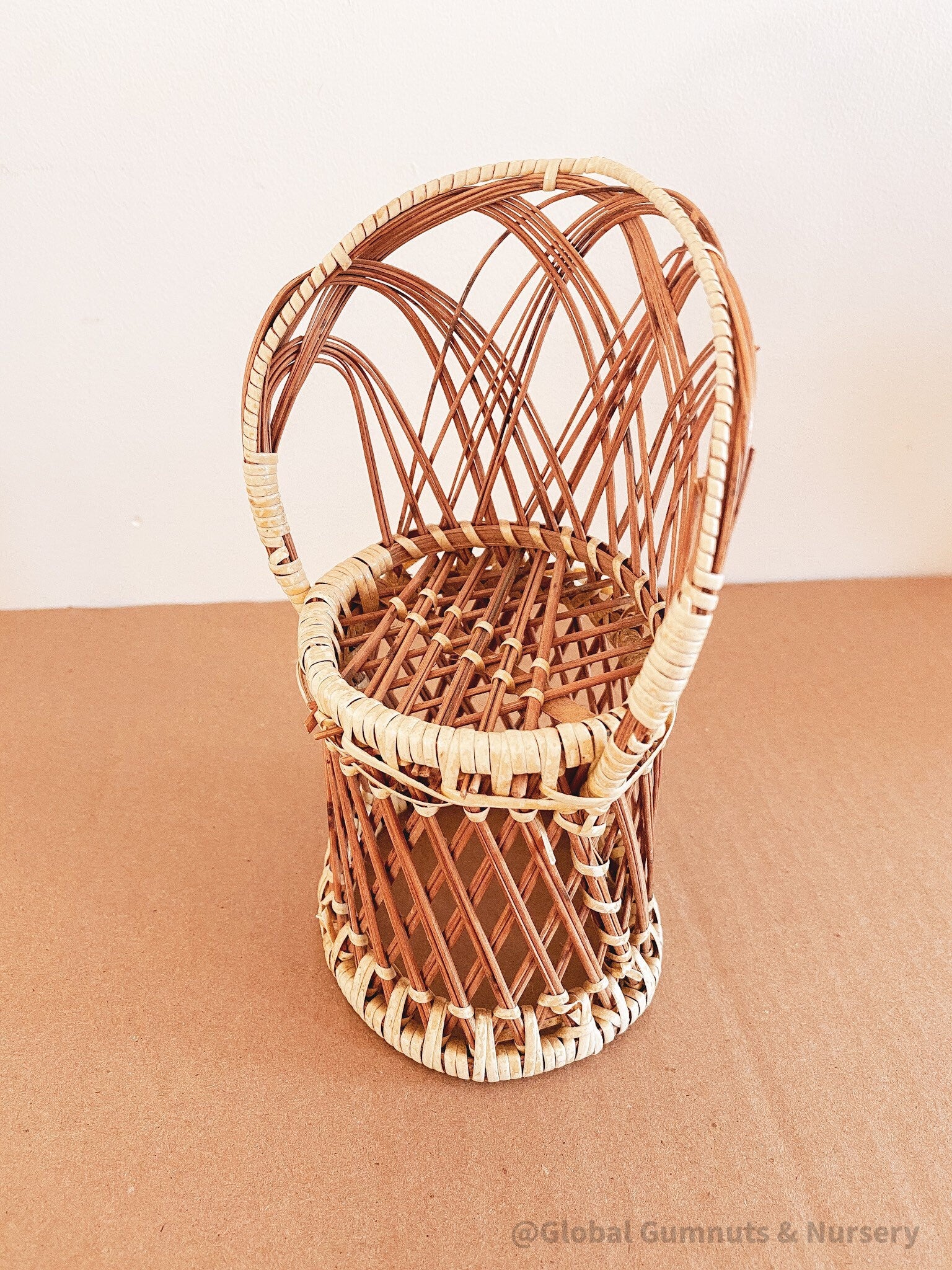 Vintage wicker doll's chair, measuring 20cm x 10cm.