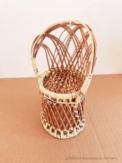 Vintage wicker doll's chair, measuring 20cm x 10cm.