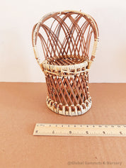 Vintage wicker doll's chair, measuring 20cm x 10cm.
