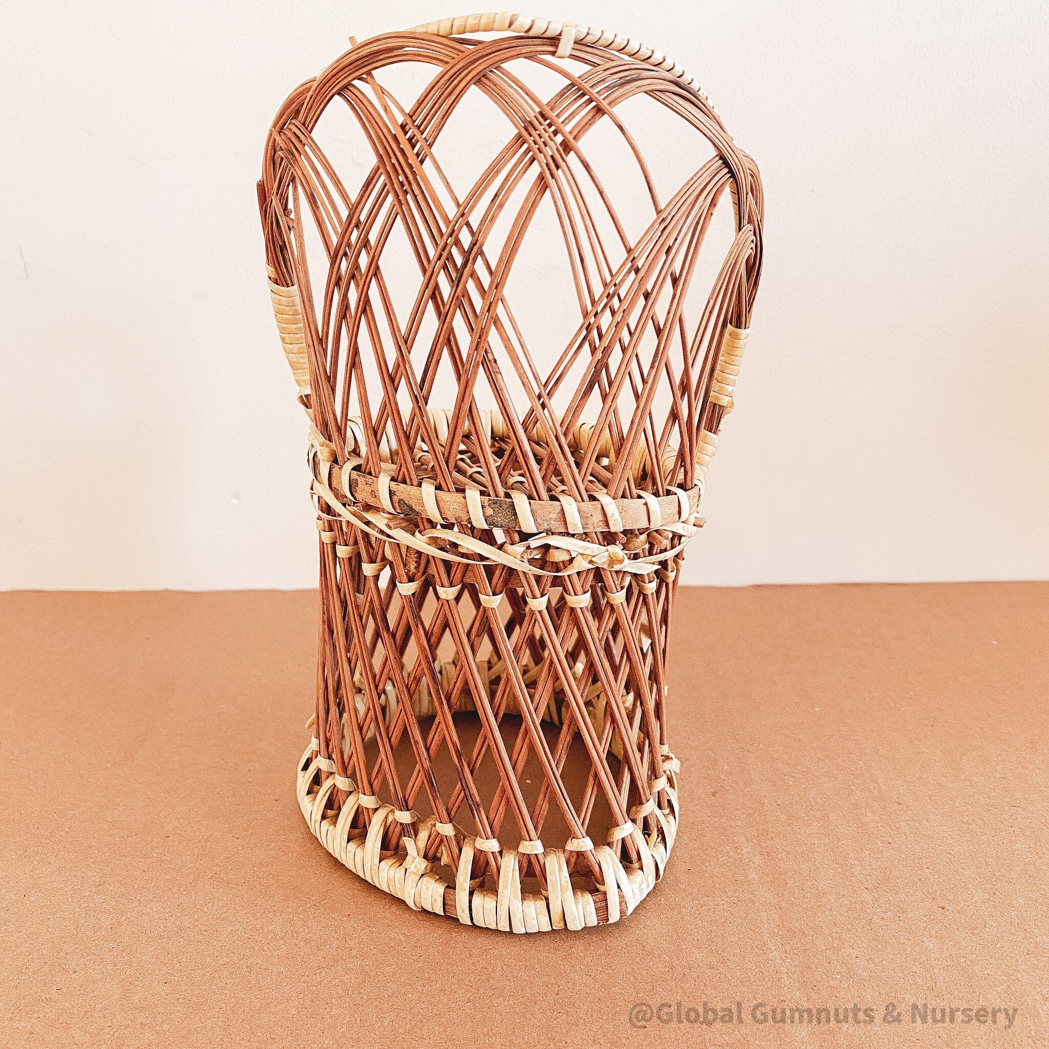 Vintage wicker doll's chair, measuring 20cm x 10cm.