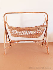 Vintage dolls rocking cot, a two-piece wicker delight.
