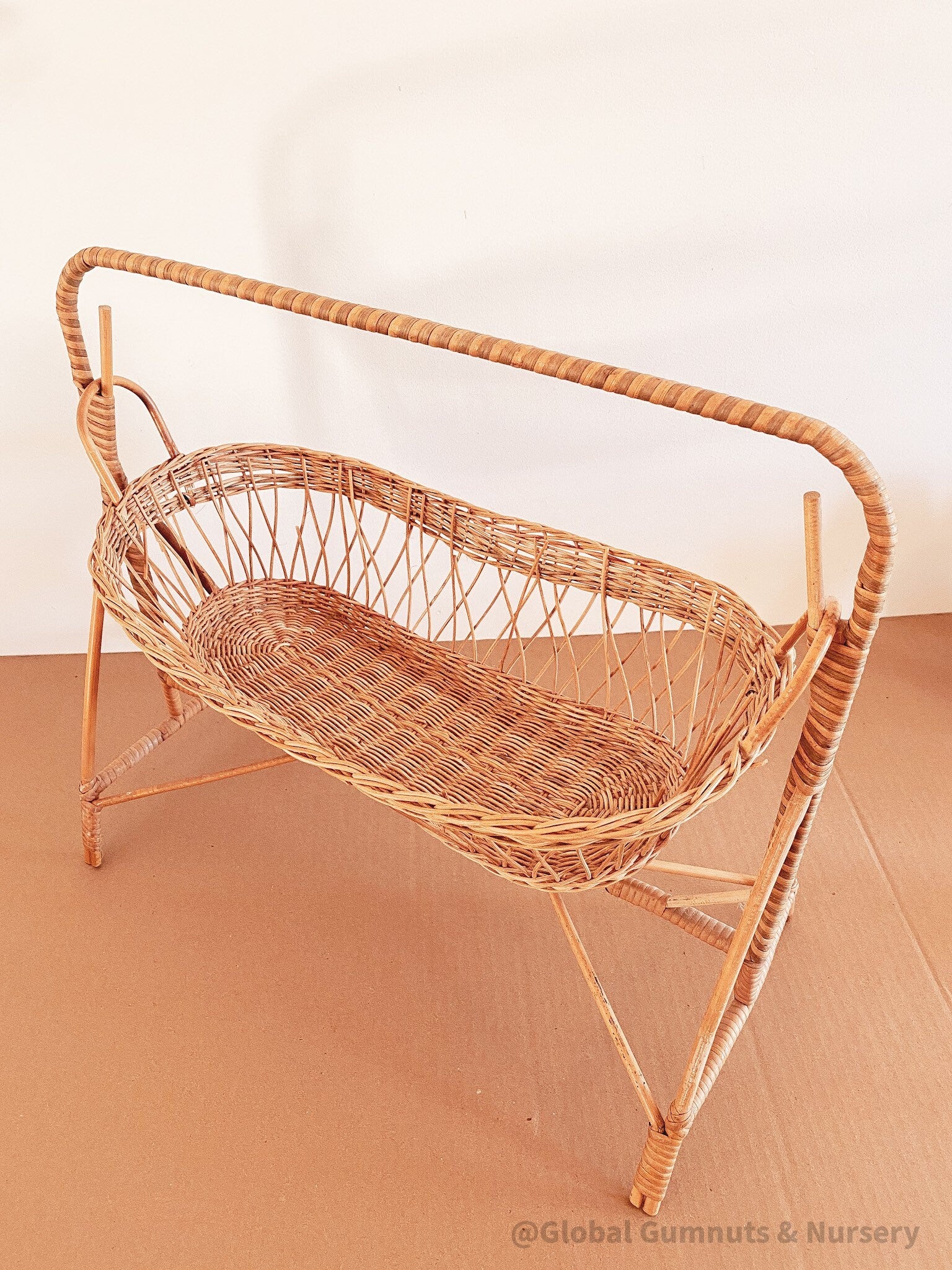 Vintage dolls rocking cot, a two-piece wicker delight.