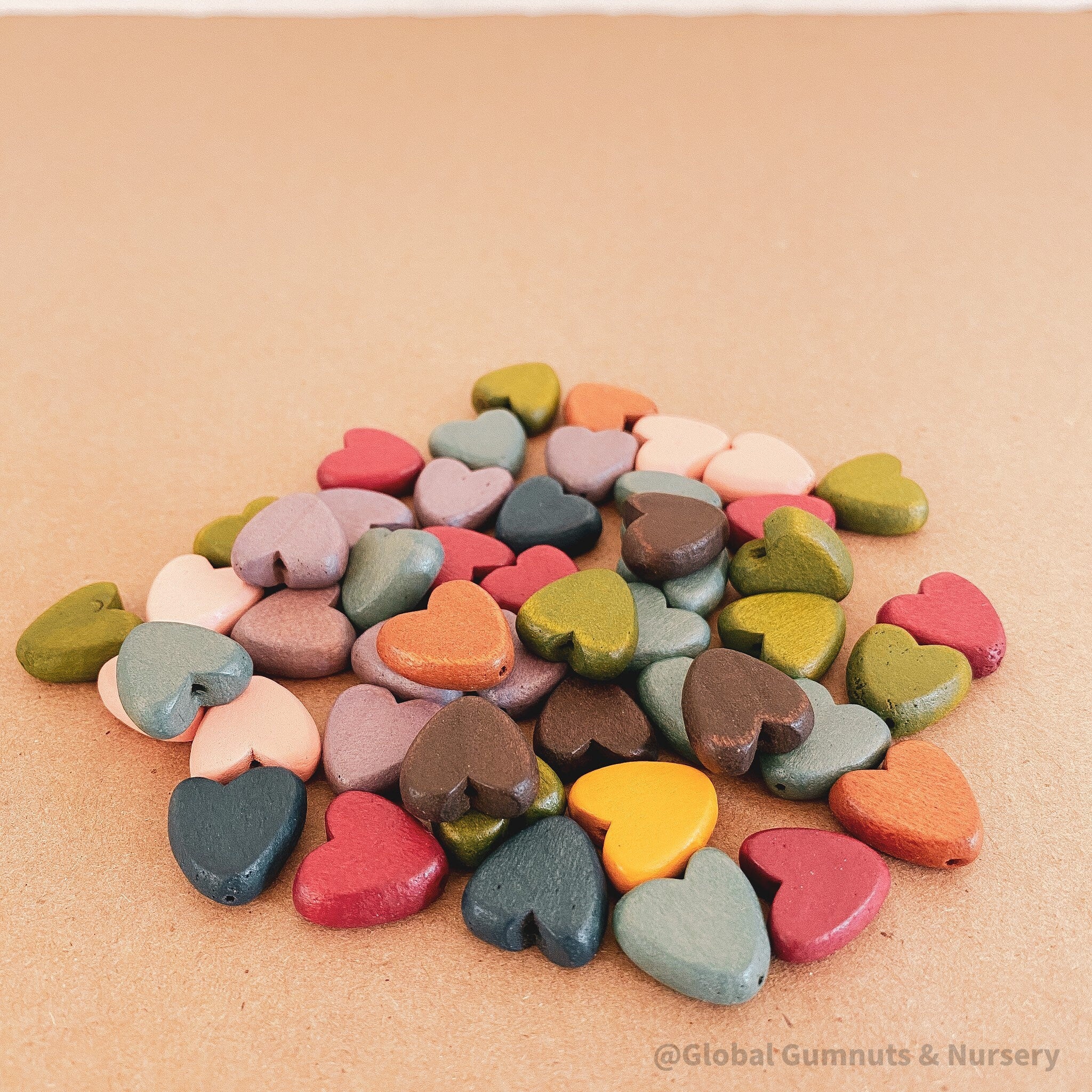 Set of 10 colorful 15mm wooden hearts, ideal for crafting, decorating, or adding charm to DIY projects.