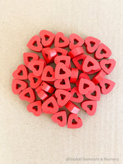 Whimsical red wooden heart beads, ideal for Valentine's Day crafts and projects.