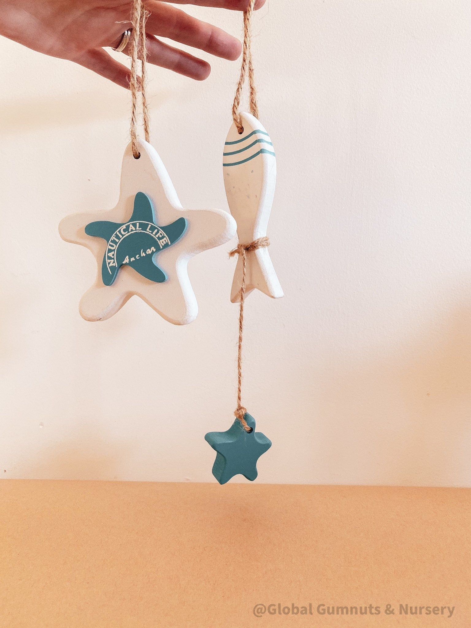 Coastal-themed wooden starfish and fish decor set, perfect for beach-inspired decor or nautical crafts.