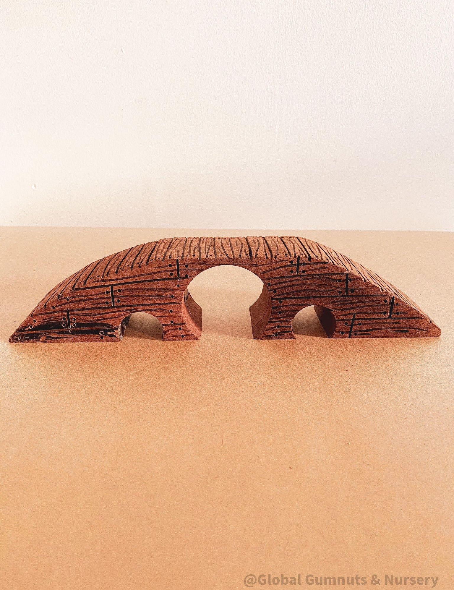 Handcrafted wooden bridge with three passages, perfect for fairy gardens or magical small-world play.
