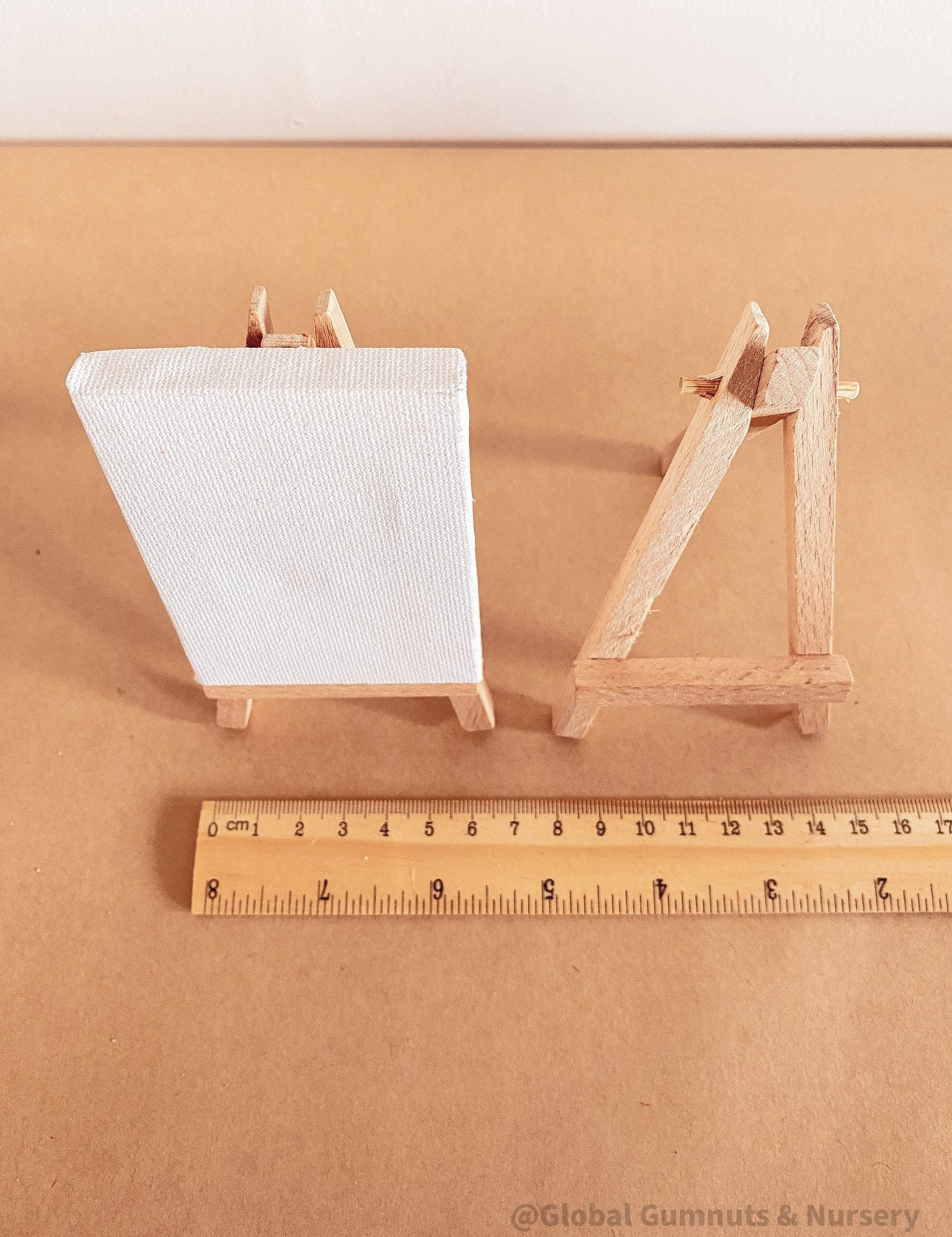 Miniature wooden easel and canvas set, ideal for inspiring tiny artists.

