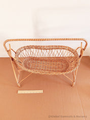 Vintage dolls rocking cot, a two-piece wicker delight.