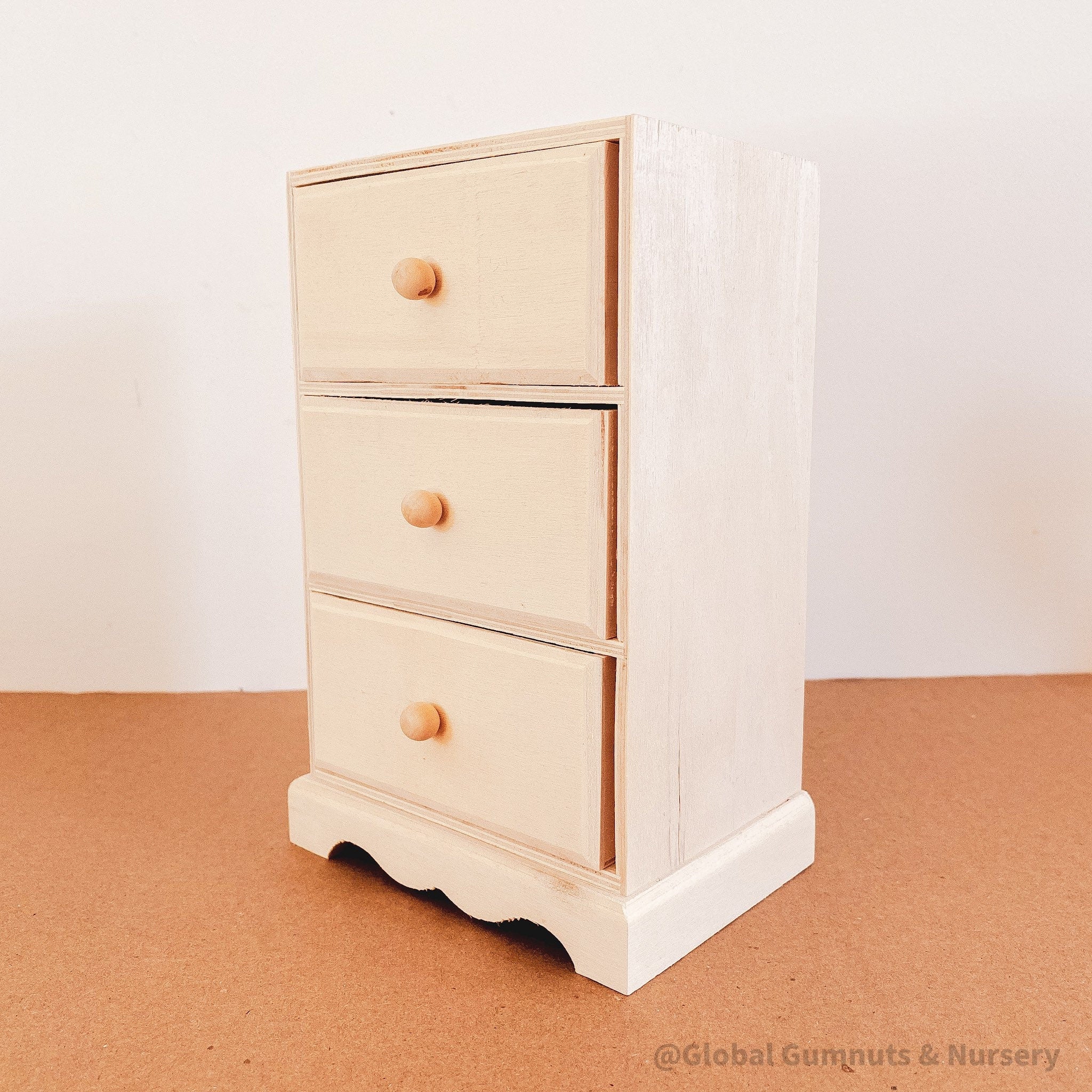 Dollhouse wooden chest of drawers, ready to paint or decorate. Perfect for miniature furniture enthusiasts.

