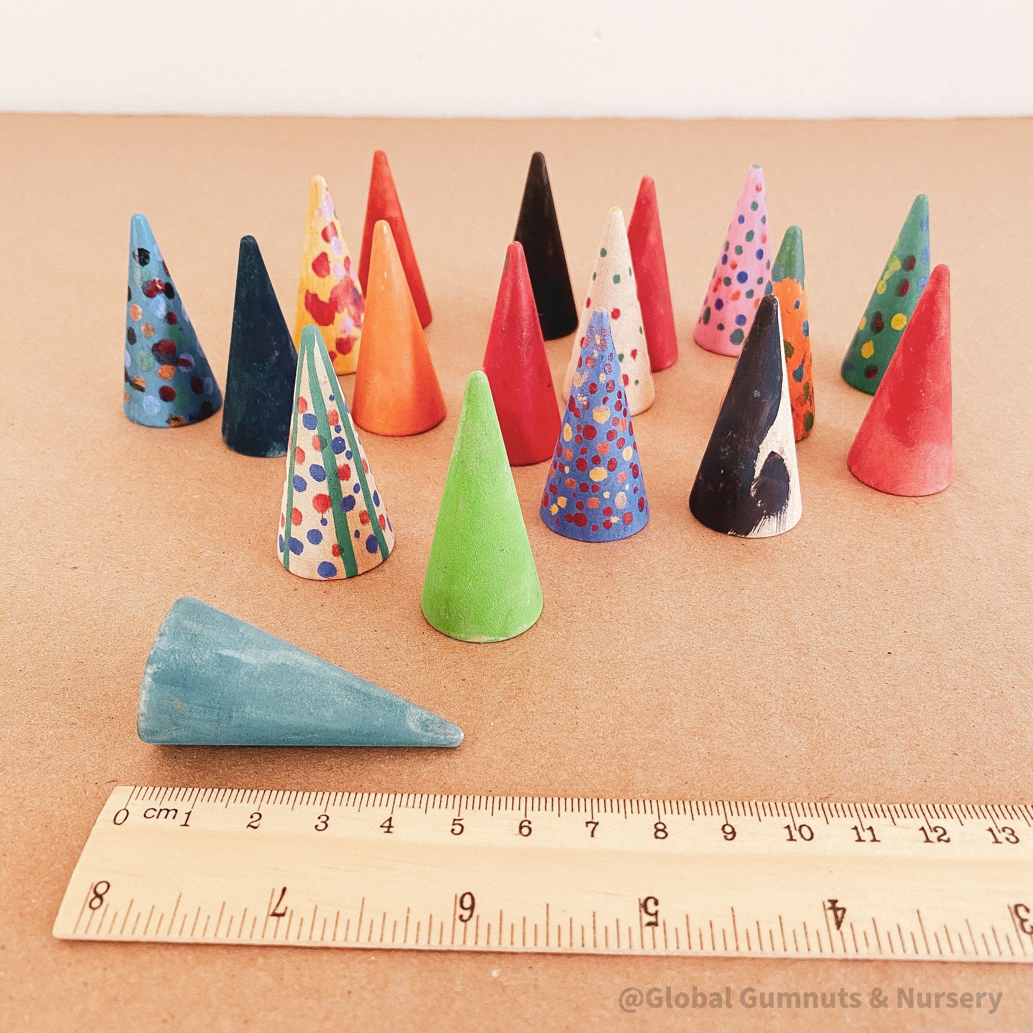 Mini wooden forest set, featuring hand-painted Christmas trees created by children.

